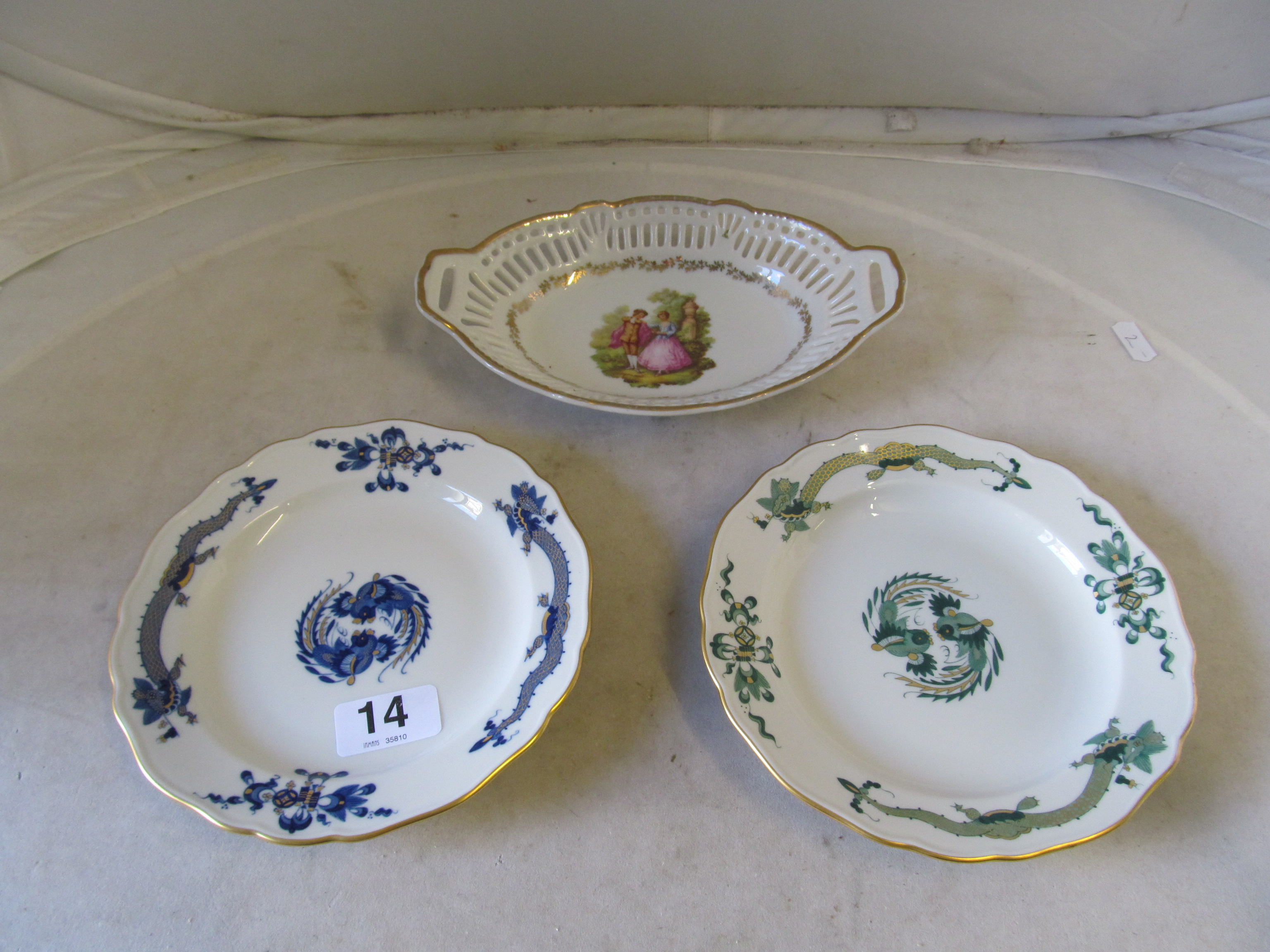 Two modern Meissen plates one blue the other green cockerel and dragon design and a Bavarian pierced