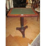 A 19th Century mahogany table inset leather top on fluted column and platform base