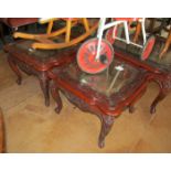 A pair of mahogany glass top tables
