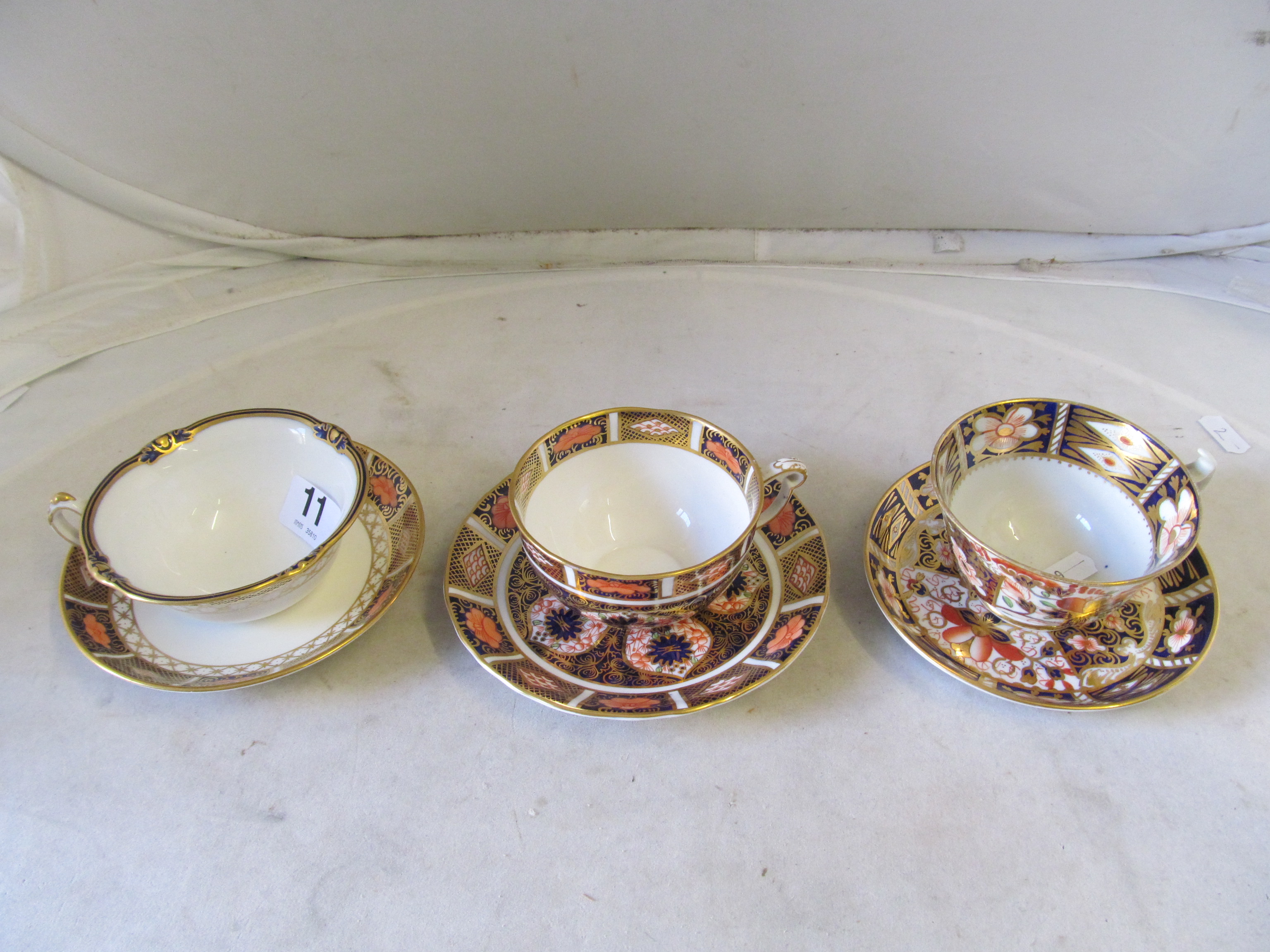 A 19th Century Derby Imari cup and two saucers (one a/f), six Royal Crown Derby cups and saucers and