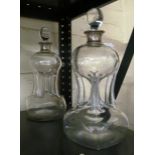 A pair of glug glug decanters with silver mounts.