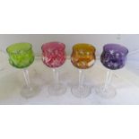 A set of four hock glasses with different coloured bowls and two others