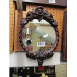 A small mirror with carved frame