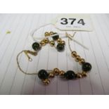 A 14K green stone necklace