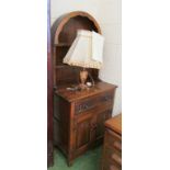 A small oak dresser with two tier plate rack above drawer and two carved panelled doors