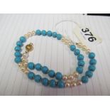 A pearl and turquoise necklace