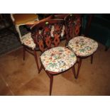 A set of four Ercol dining chairs with stylized Prince of Wales Feather backs
