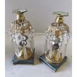 A pair of gilt lustre candlesticks on marble bases.