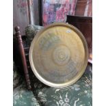 An eastern brass tray top table on folding stand