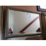 A modern gilt and marble effect mirror