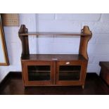 An Edwardian oak wall cabinet with two glazed doors