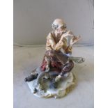 A Capodimonte figure man threading needle signed Tosca