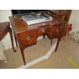 A mahogany dressing table with concave front and three drawers