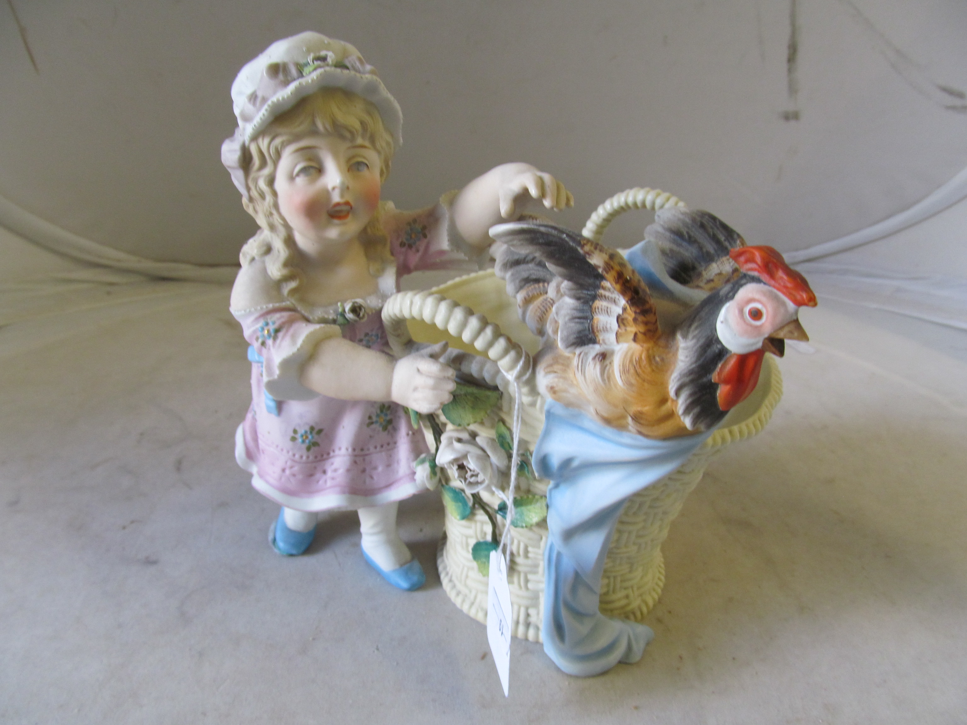 A continental bisque vase girl with cockerel in basket