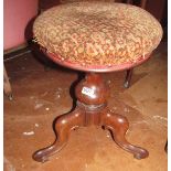 A piano stool on tripod base with revolving top.