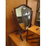 A shield shaped swing toilet mirror