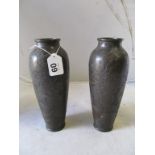 A pair of Japanese bronze vases decorated scenes of birds and flowers.