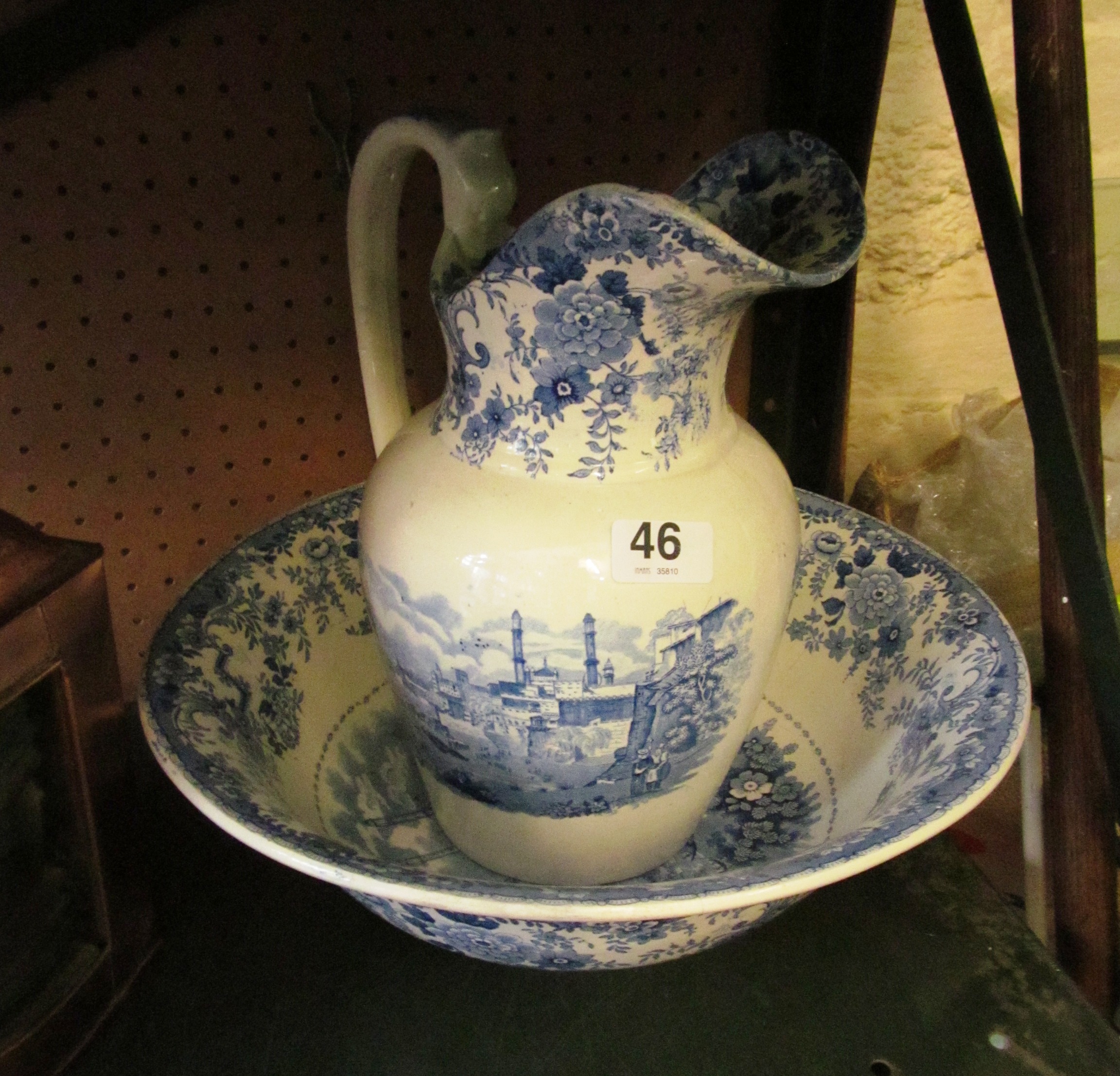 A blue and white wash jug and bowl river and town scene