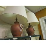 A pair of pottery lamps with ropetwist effect side handles and shades