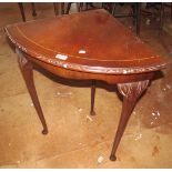 A corner occasional table on cabriole legs