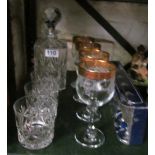 A glass decanter and three Webbs crystal glasses and 4 gilt rim glasses