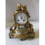 A 19th Century French gilt mantel clock with Sevres style porcelain plaques two birds to top and