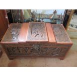 An Oriental carved camphor chest