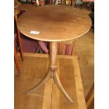 An oval mahogany pillar and tripod table