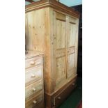 A pine double wardrobe with drawer under