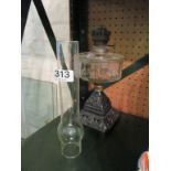 A Victorian oil lamp on metal base