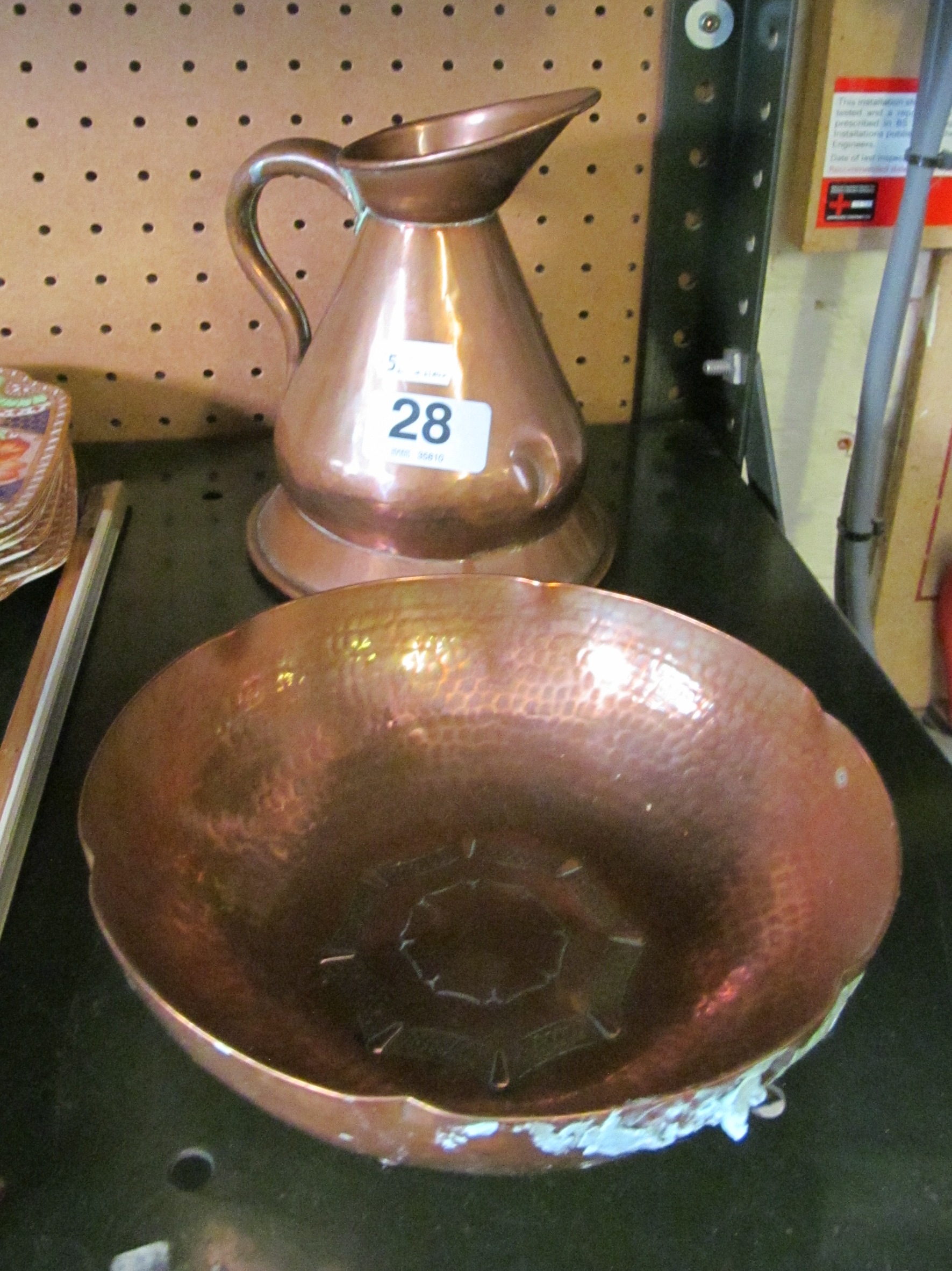 A Borrowdale hand beaten copper bowl and 19th Century copper measuring jug.