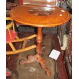 A 19th Century circular topped table inlaid flowers on turned tripod support.