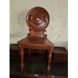 A Victorian oak hall chair with circular carved back