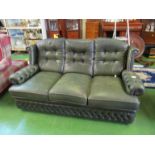 A green leather settee