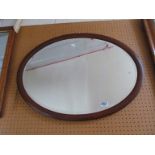 An Edwardian oval mirror