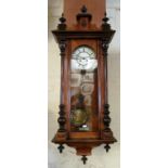 A 19th Century walnut wall clock with turned finial top, cream dial and glass door revealing