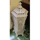 A cast iron white painted pierced heater.