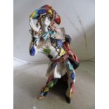A large pottery Harlequin figure signed D Marioni