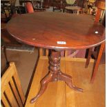 A 19th Century mahogany tip-up action circular occasional table on tripod supports.