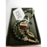 A greenstone necklace and a gent's signet ring