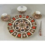 A Royal Crown Derby Imari plate, two coffee cups and saucers, a bowl and a paperknife