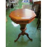 A Victorian walnut octagonal sewing table on tapered and tripod base with pink and cream satin
