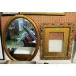 An oval gilt mirror and a gilt frame