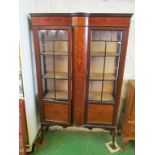 An Edwardian mahogany and inlaid display cabinet with bow fronted centre section on tapered