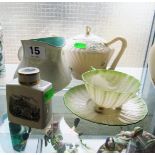 A Belleek teapot, cup and saucer, Poole jug and Royal Worcester lidded jar