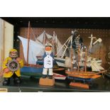 Five small model boats and three sailor figures