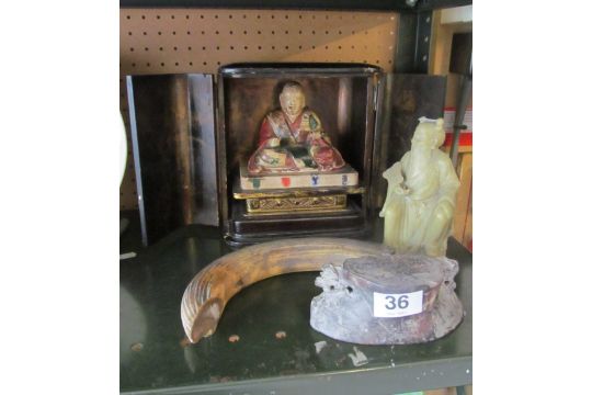 A two door small wooden cabinet opening to reveal painted Buddha, a figure holding fan and a Hippo - Image 1 of 2