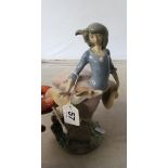 A Lladro lady running with dog (dog reglued)