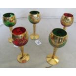 A set of five Venetian coloured glass and gilt floral pattern drinking glasses