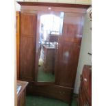 An Edwardian mirror door wardrobe with drawer under